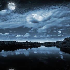 Moonlight over a lake by Jaroslaw Grudzinski